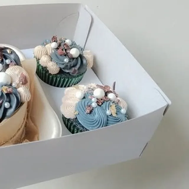 Cupcakes piped with buttercream swirls and pearls