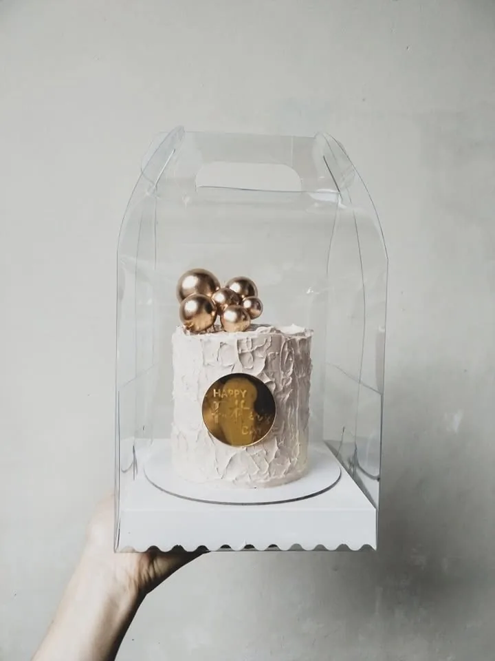 A minicake in its clear acetate box